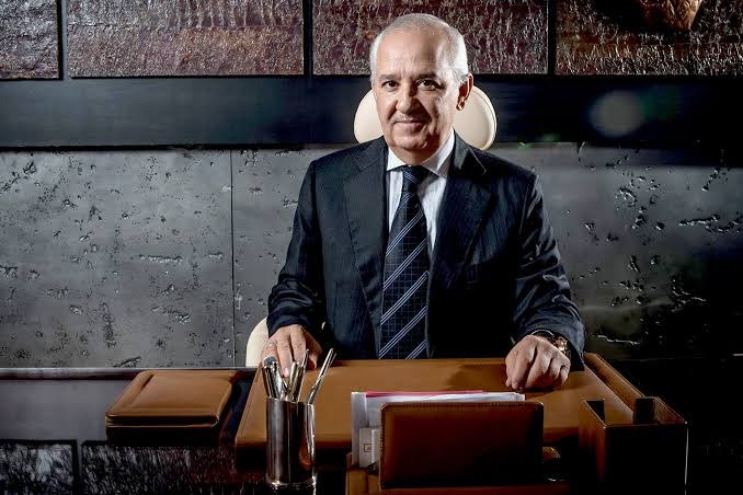 Anas Sefrioui seated at an executive desk in a dark panelled office